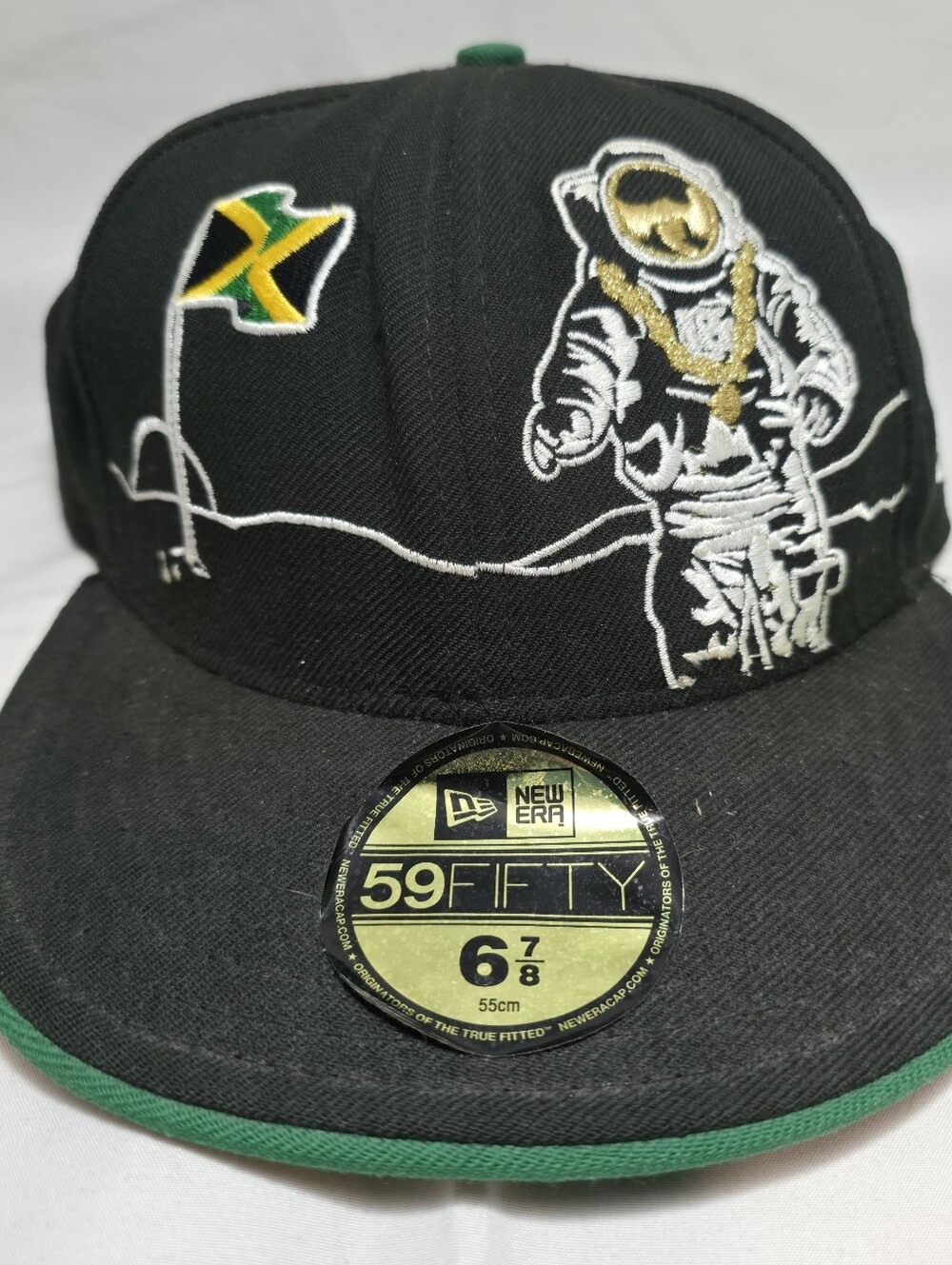 New Era Black Fitted Cap 6-7/8 with Gold Astronaut and Jamaican Flag